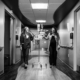 Woman in labor walking down hall with Madison Women's Health OBGYN providers
