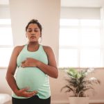 Pregnant woman taking a prenatal yoga class
