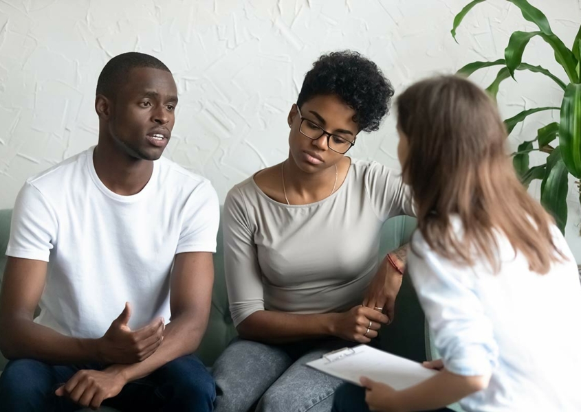 Couple doing prenatal genetic testing with genetic counselor