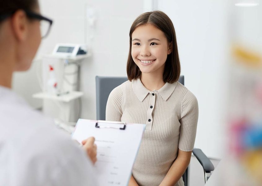 Teen smiling at her first gynecology appointment