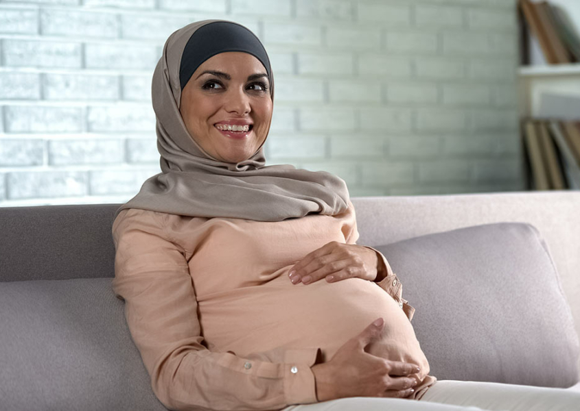 Woman holding pregnant belly