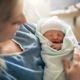 Mother with her newborn baby at the hospital after induced labor delivery