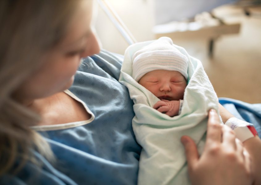 Mother with her newborn baby at the hospital after induced labor delivery