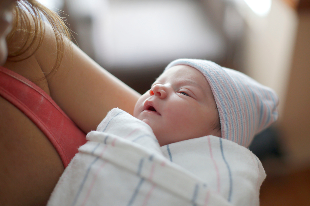 a-mother-holds-her-swaddled-newborn-baby-in-the-hospital-madison