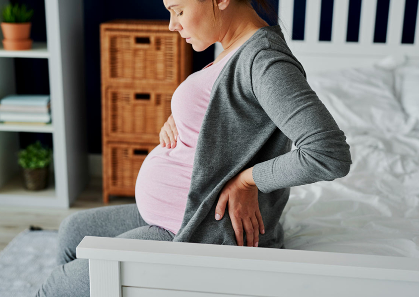 Woman experiencing lower back pain during pregnancy