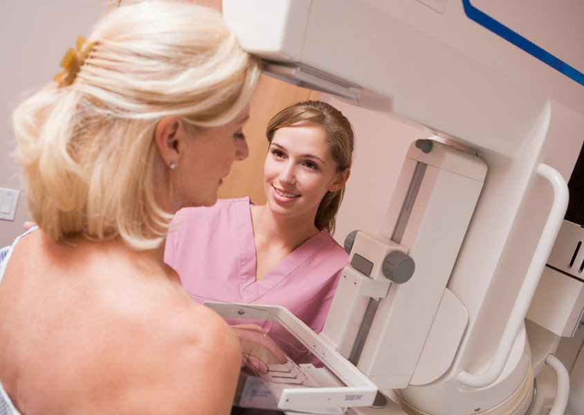 Provider giving woman a mammogram