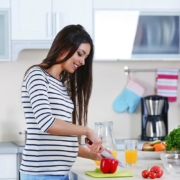 Woman smiling in kitchen who is pregnant after miscarriage