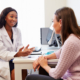 patient receiving consultation during well-woman visit