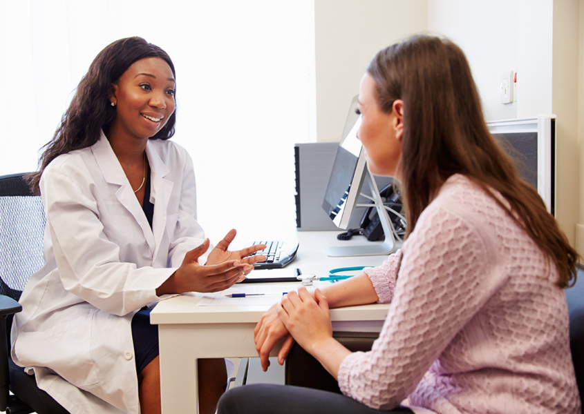 patient receiving consultation during well-woman visit