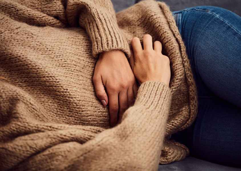 Woman lying down while recovering from a hysterectomy